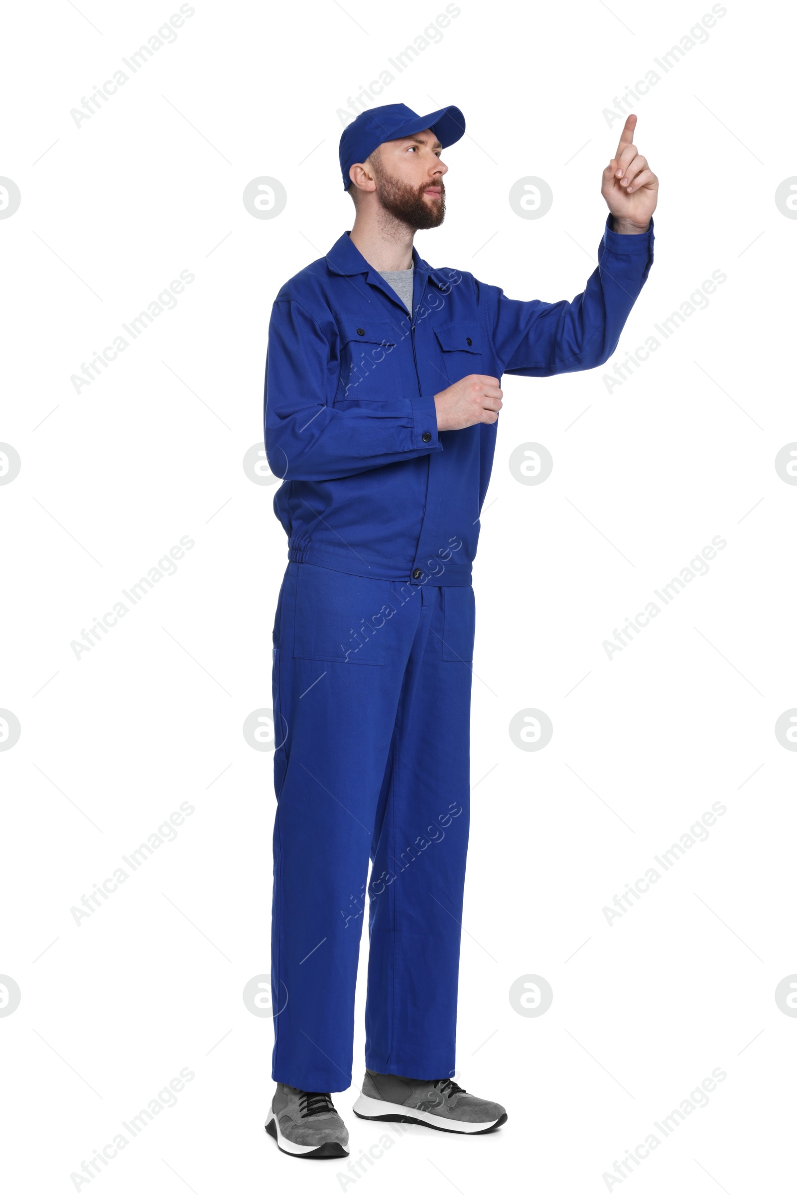 Photo of Professional auto mechanic pointing at something on white background