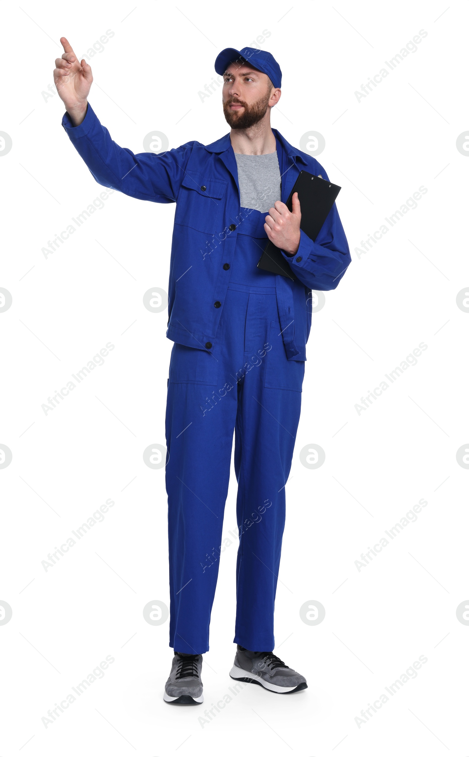 Photo of Professional auto mechanic with clipboard pointing at something on white background