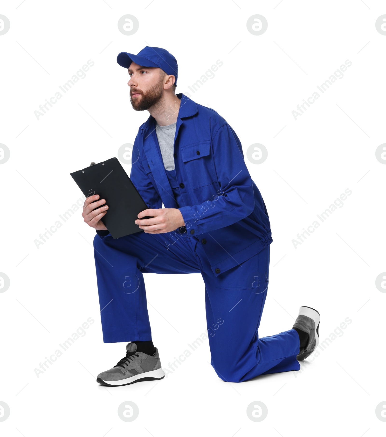 Photo of Professional auto mechanic with clipboard on white background