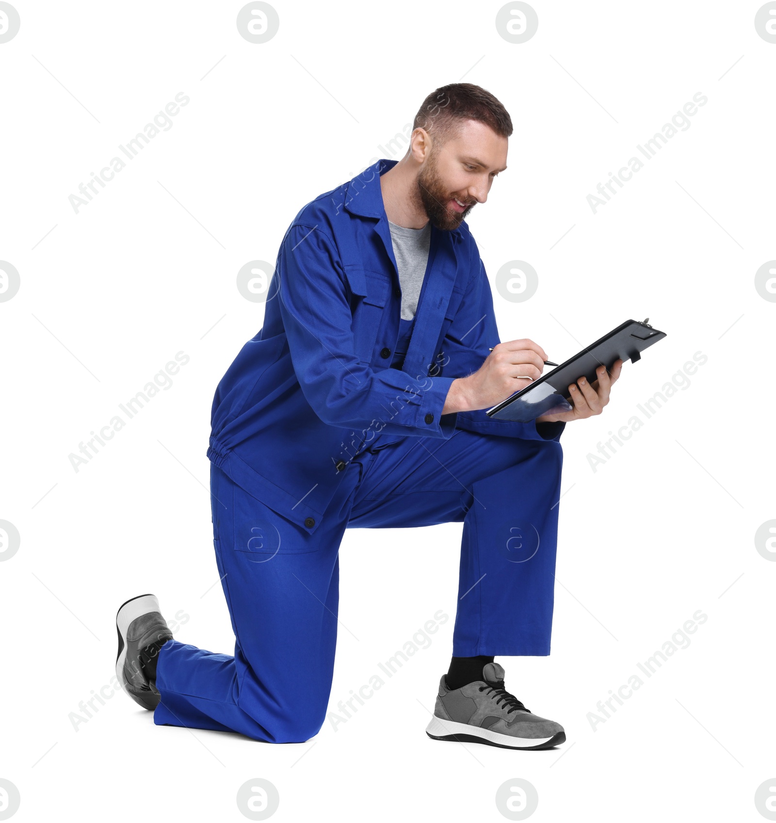 Photo of Professional auto mechanic with clipboard and pen on white background