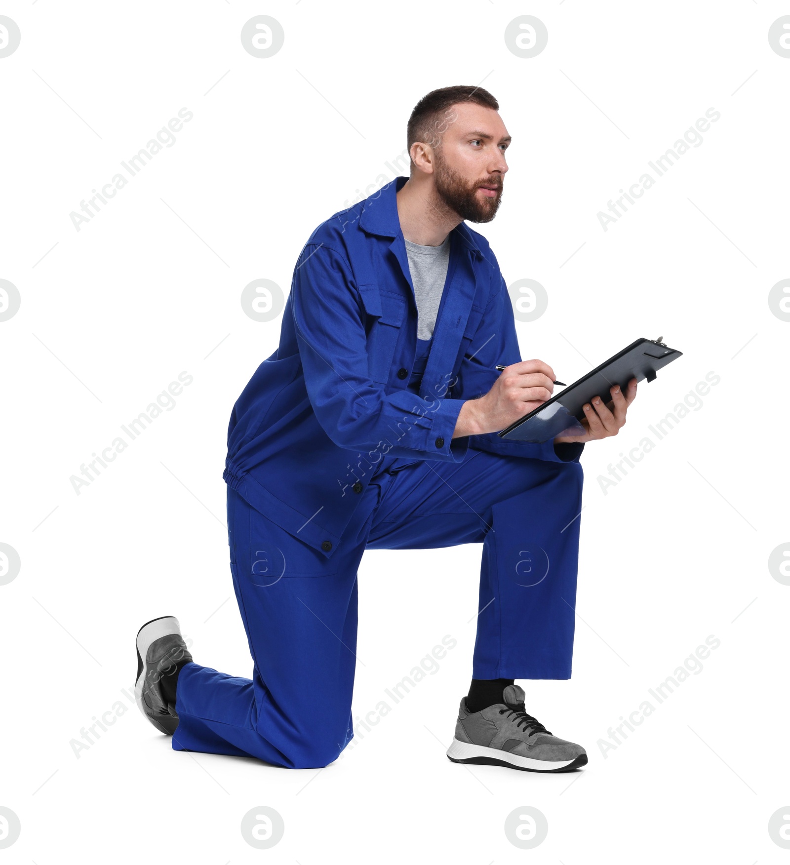 Photo of Professional auto mechanic with clipboard and pen on white background