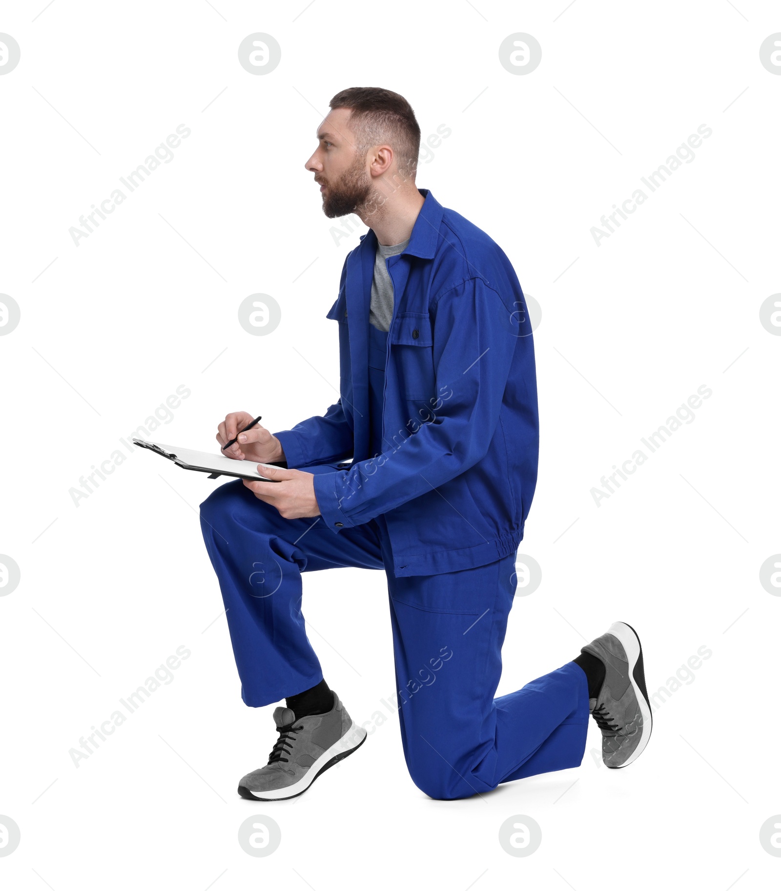 Photo of Professional auto mechanic with clipboard and pen on white background