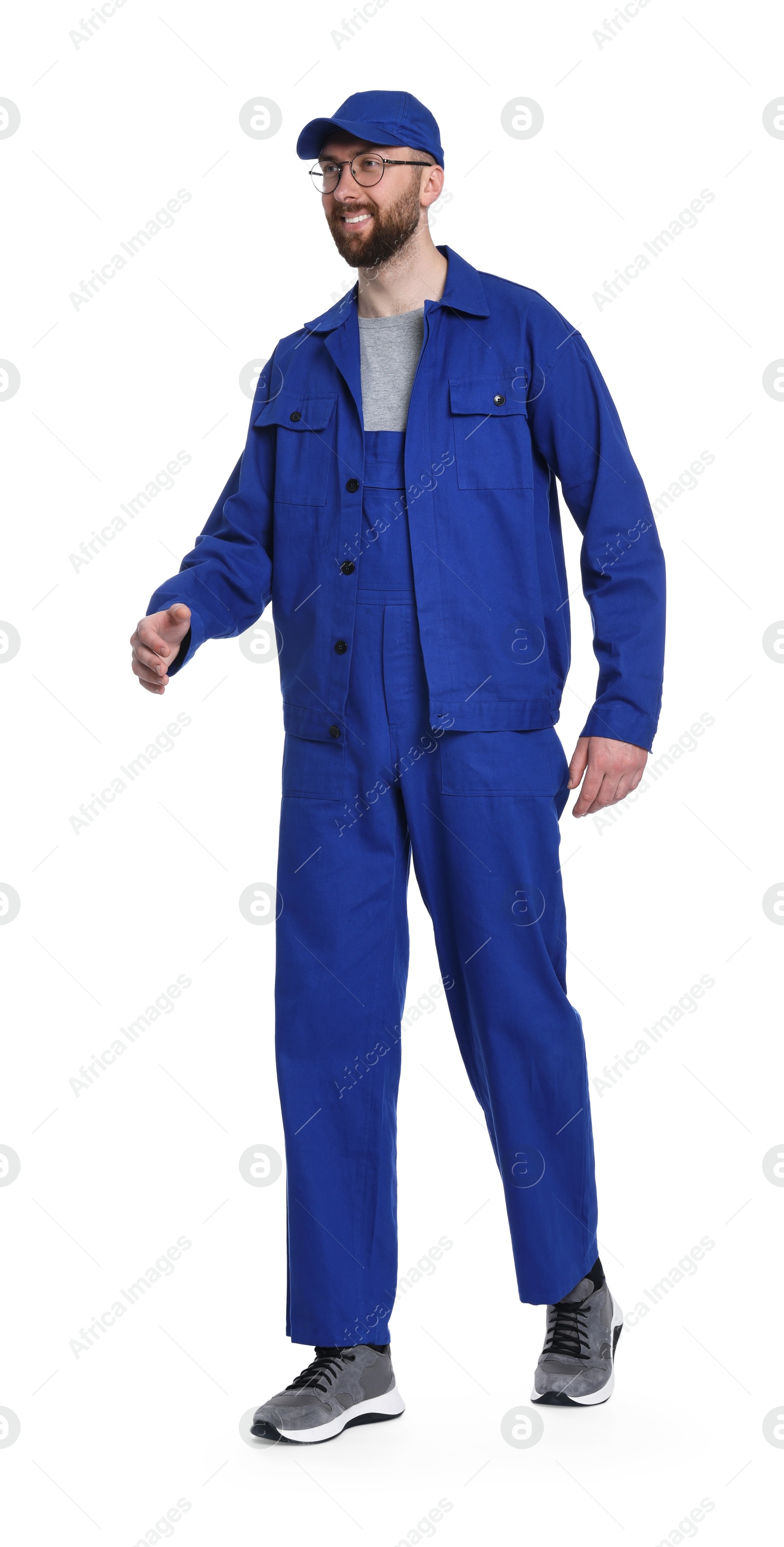 Photo of Professional auto mechanic walking on white background