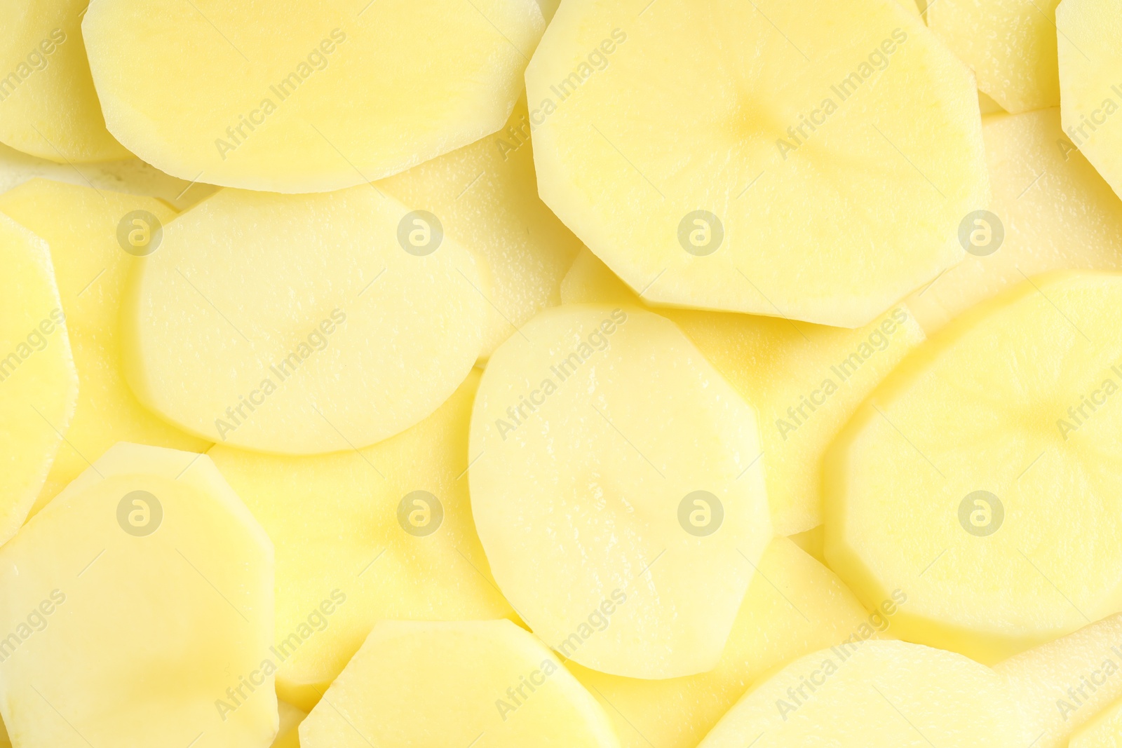 Photo of Cut fresh raw potatoes as background, top view