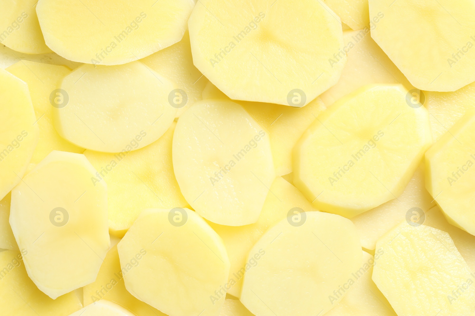 Photo of Cut fresh raw potatoes as background, top view