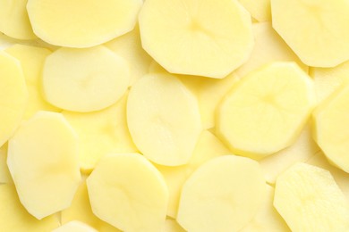 Photo of Cut fresh raw potatoes as background, top view