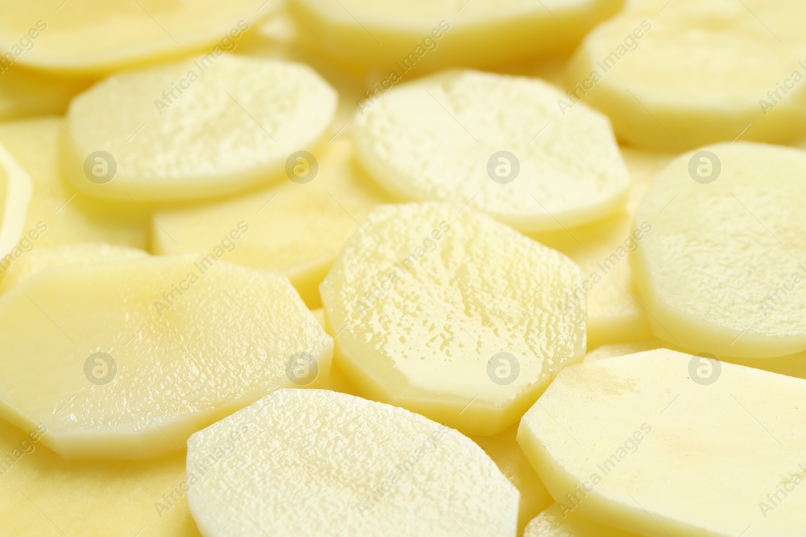 Photo of Cut fresh raw potatoes as background, closeup