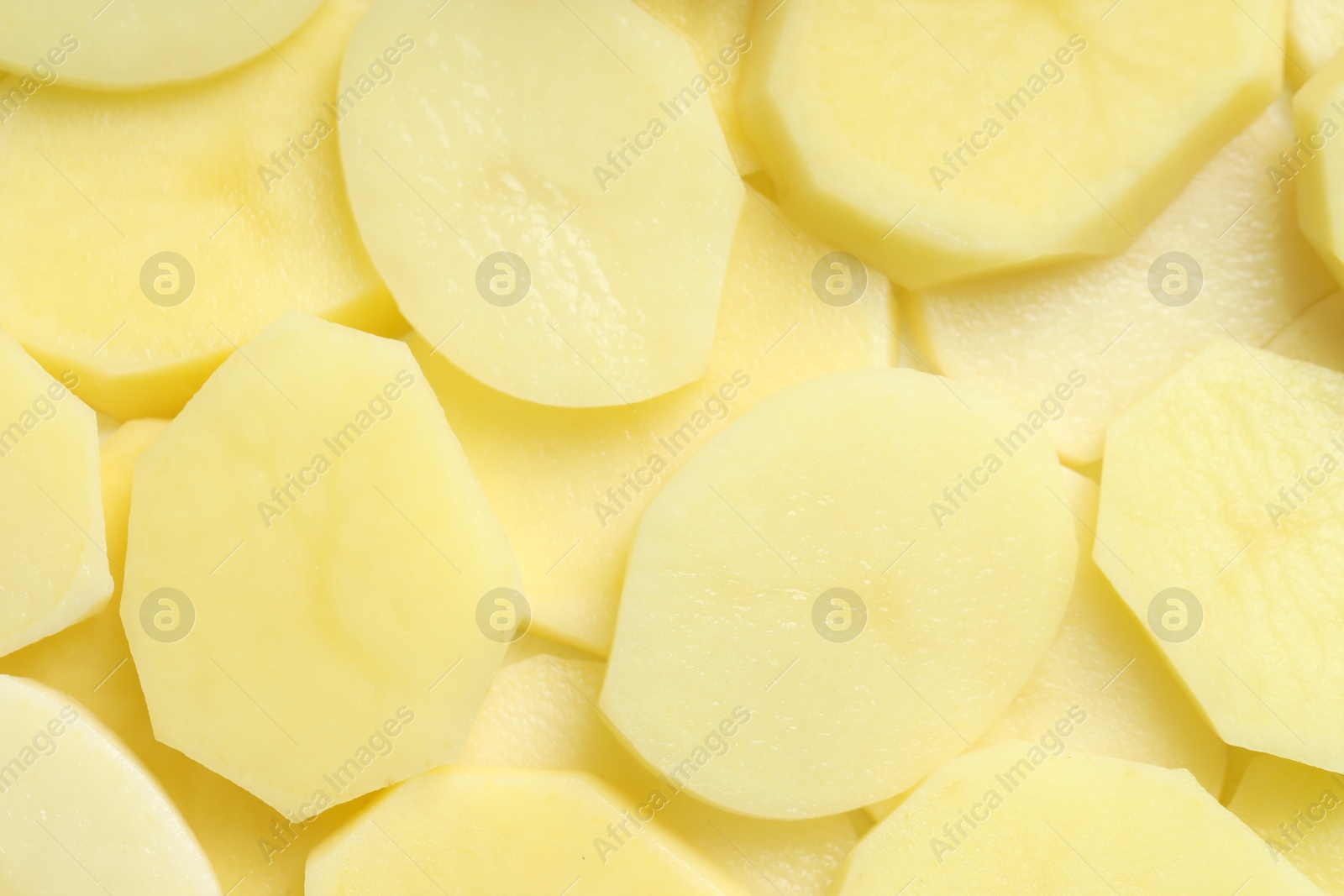 Photo of Cut fresh raw potatoes as background, top view