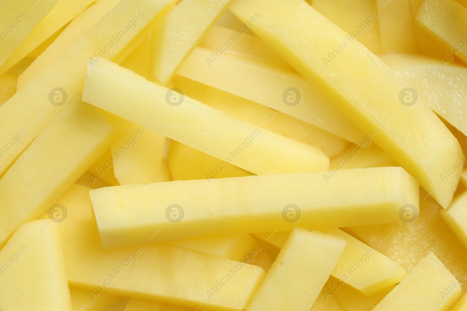 Photo of Cut fresh raw potatoes as background, closeup