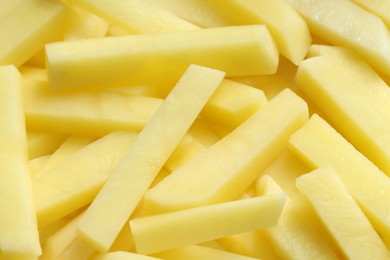 Photo of Cut fresh raw potatoes as background, closeup