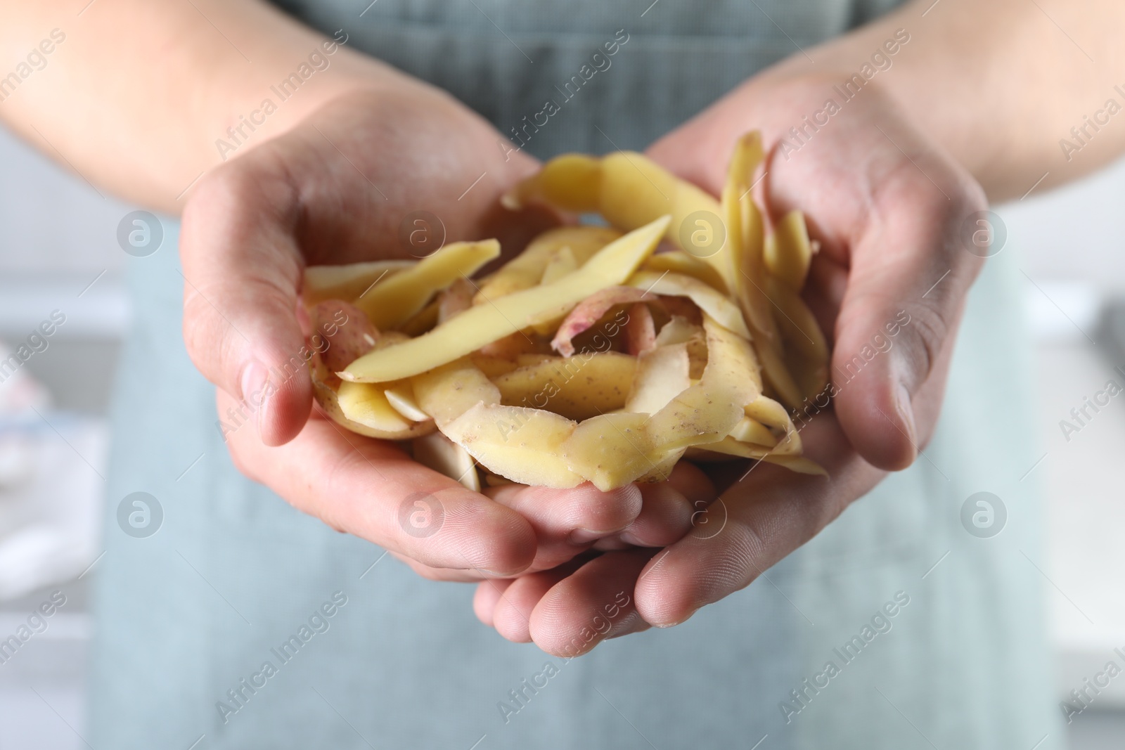 Photo of Man with many potato peels, closeup view