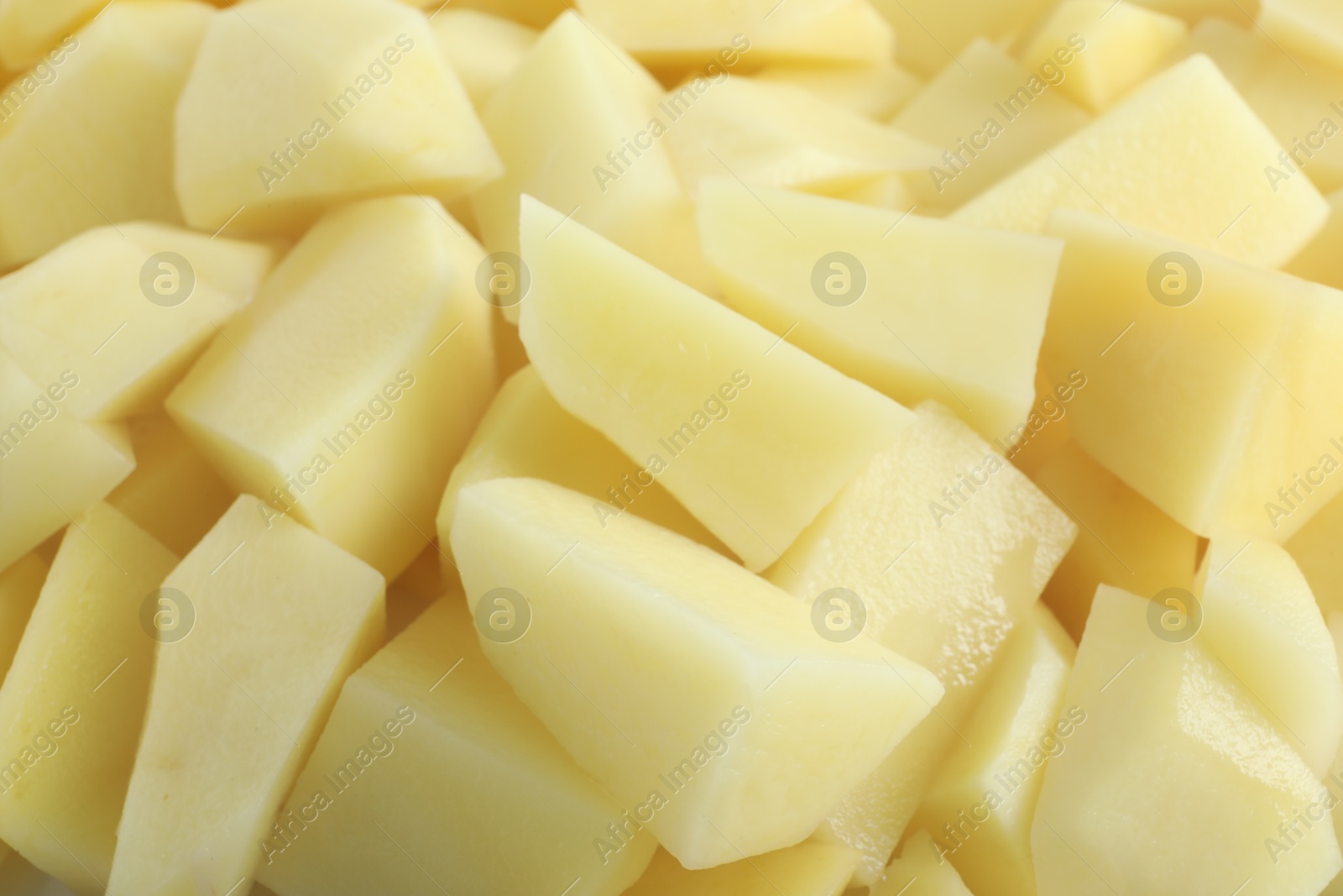 Photo of Peeled fresh raw potatoes as background, closeup