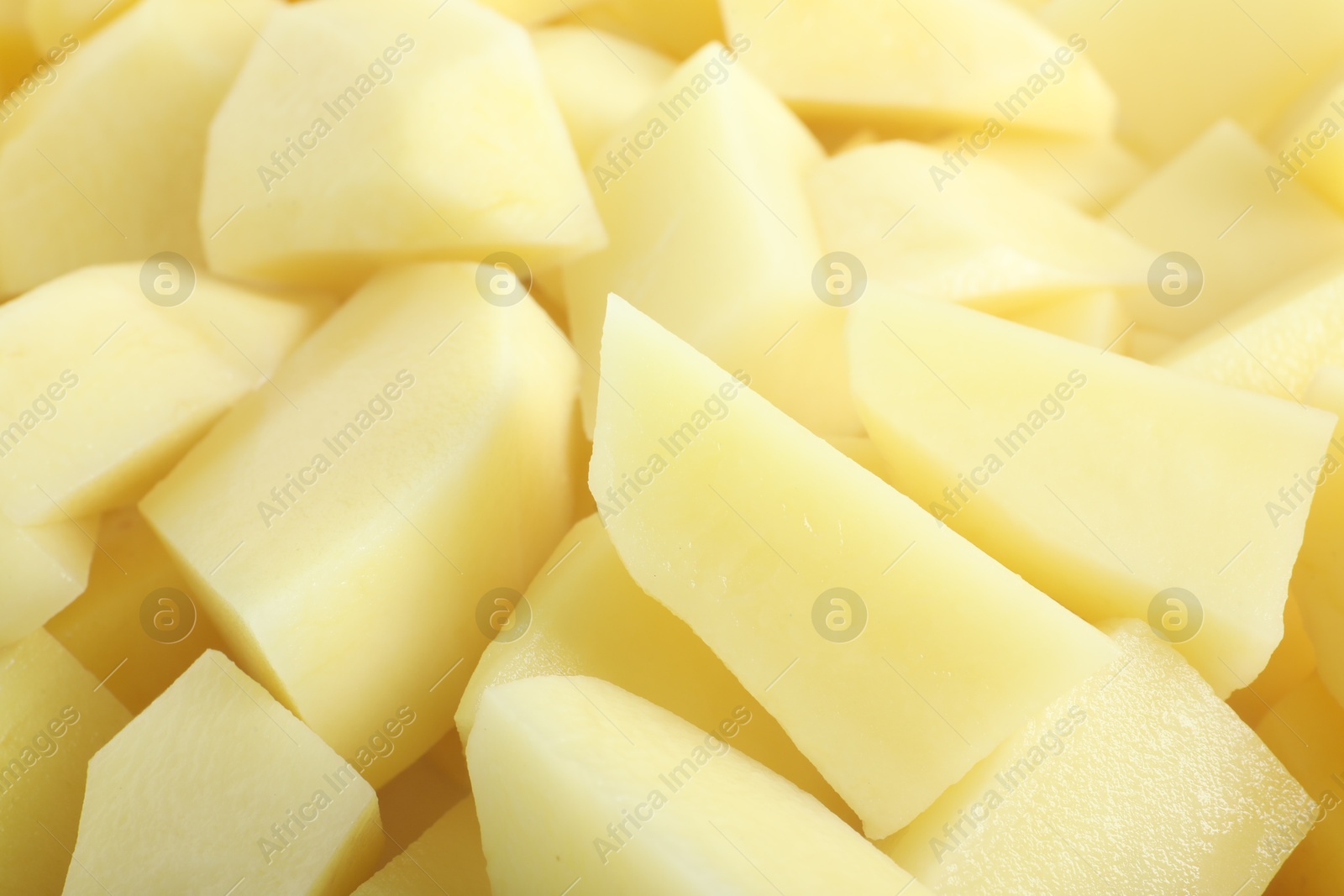 Photo of Peeled fresh raw potatoes as background, closeup