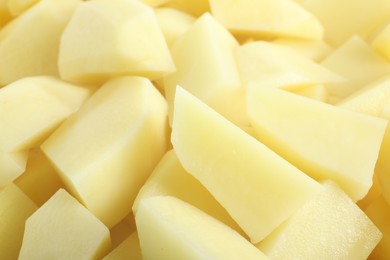 Photo of Peeled fresh raw potatoes as background, closeup