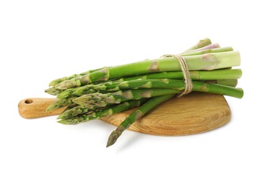 Photo of Board with bunch of fresh green asparagus stems isolated on white