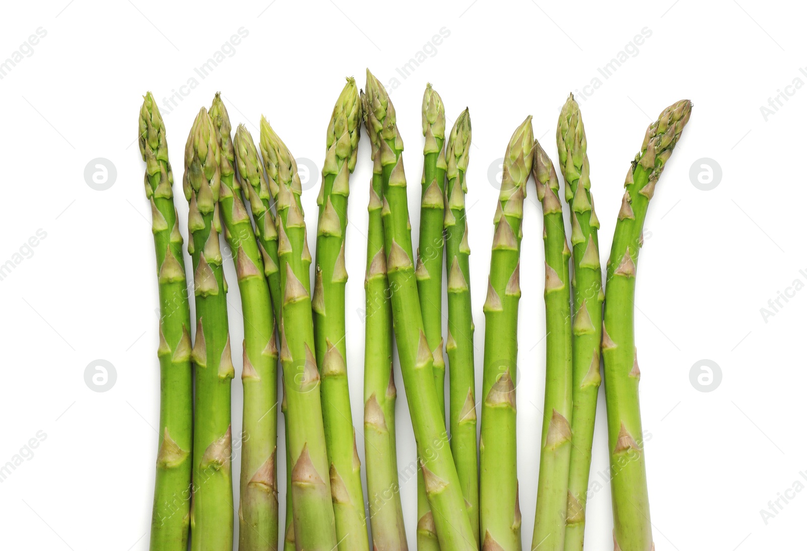 Photo of Fresh green asparagus stems isolated on white, top view