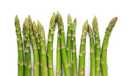 Photo of Fresh green asparagus stems isolated on white, top view