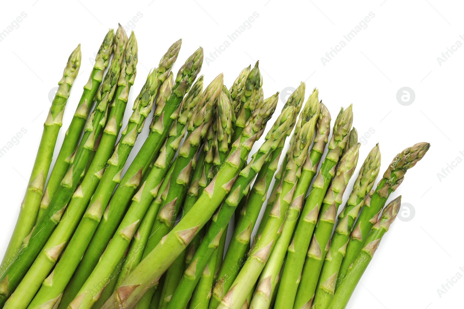 Photo of Fresh green asparagus stems isolated on white, top view