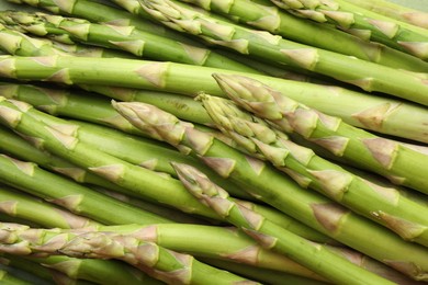 Fresh green asparagus stems as background, top view