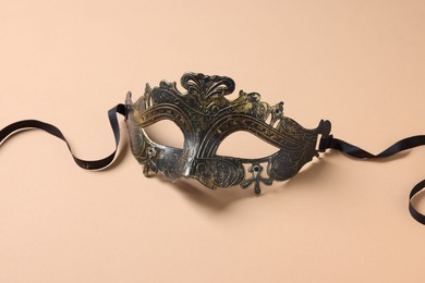 Photo of One beautiful carnival mask on beige background