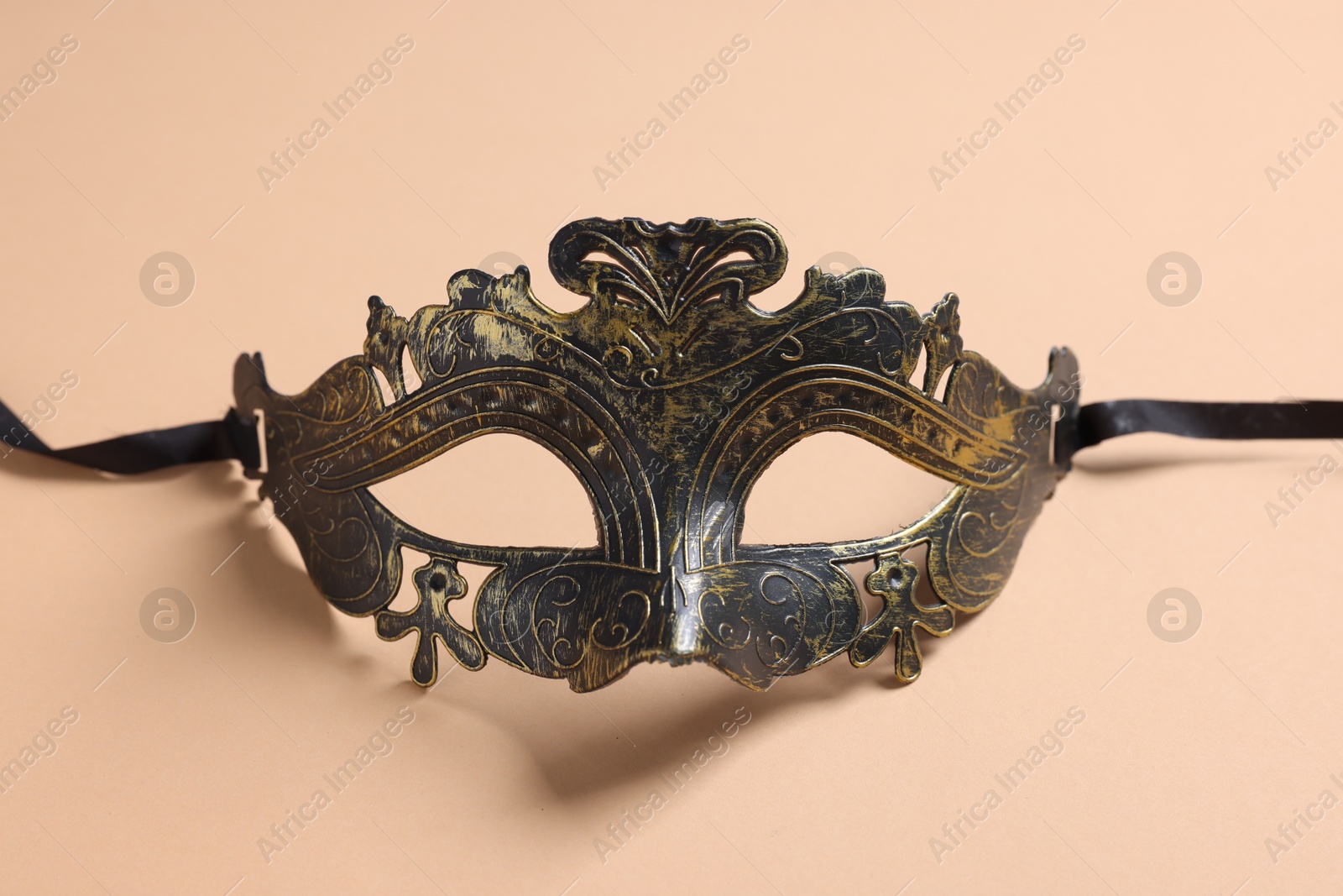 Photo of One beautiful carnival mask on beige background