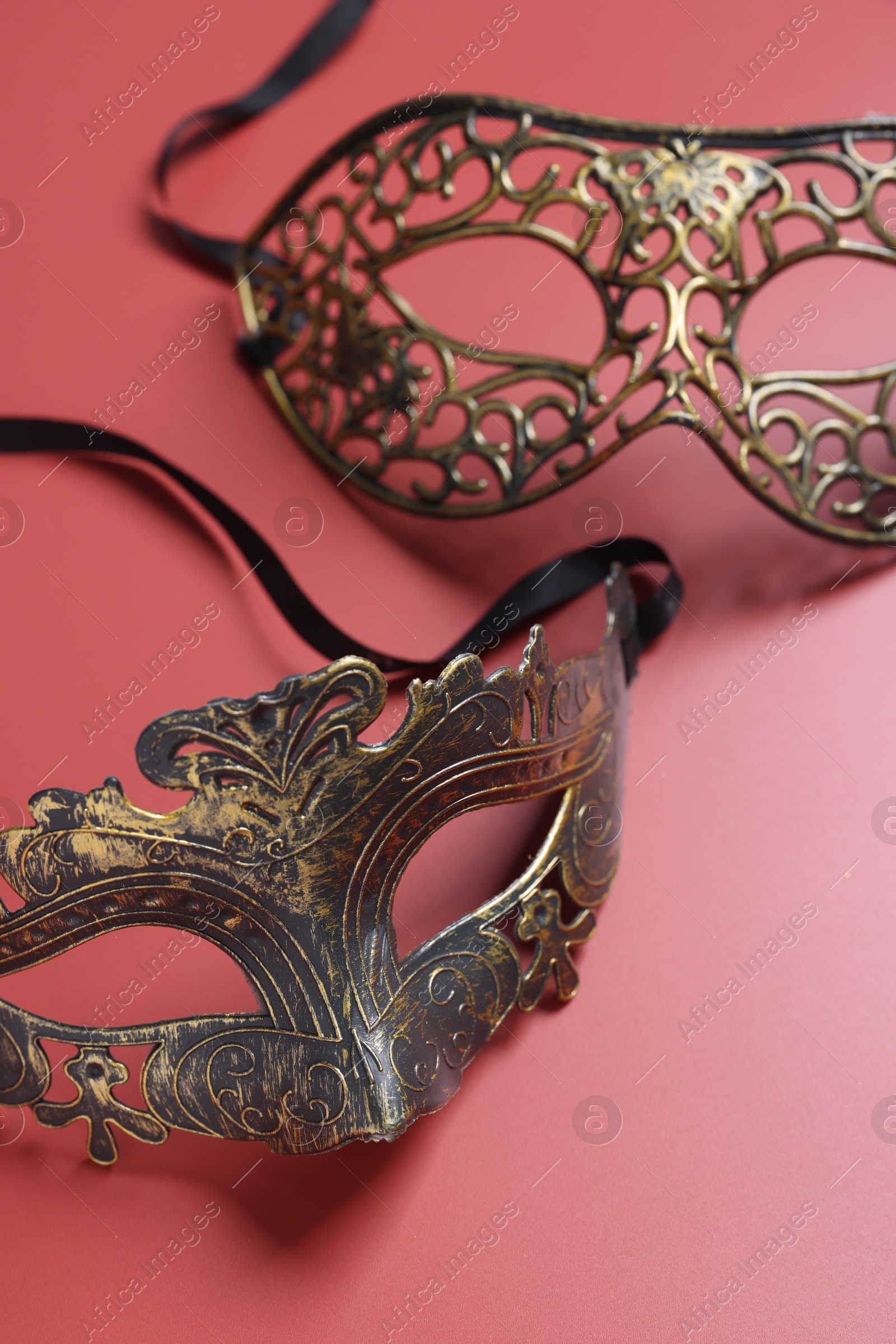 Photo of Two beautiful carnival masks on red background