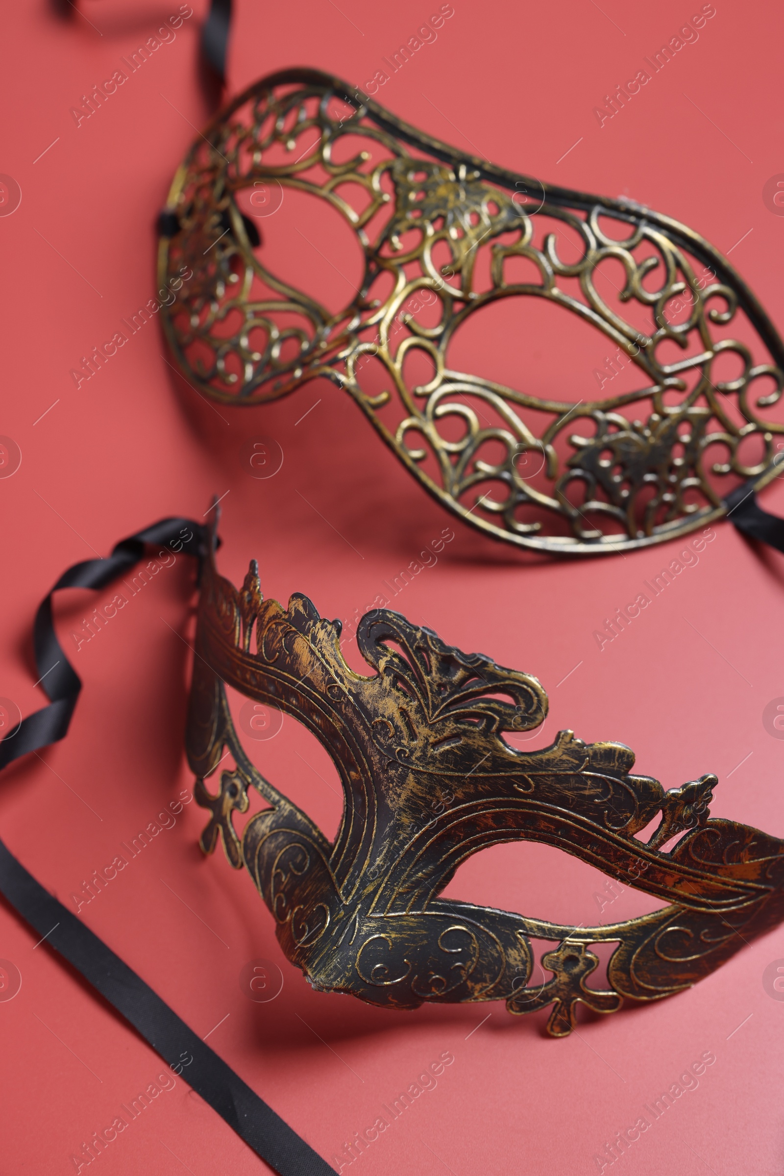 Photo of Two beautiful carnival masks on red background