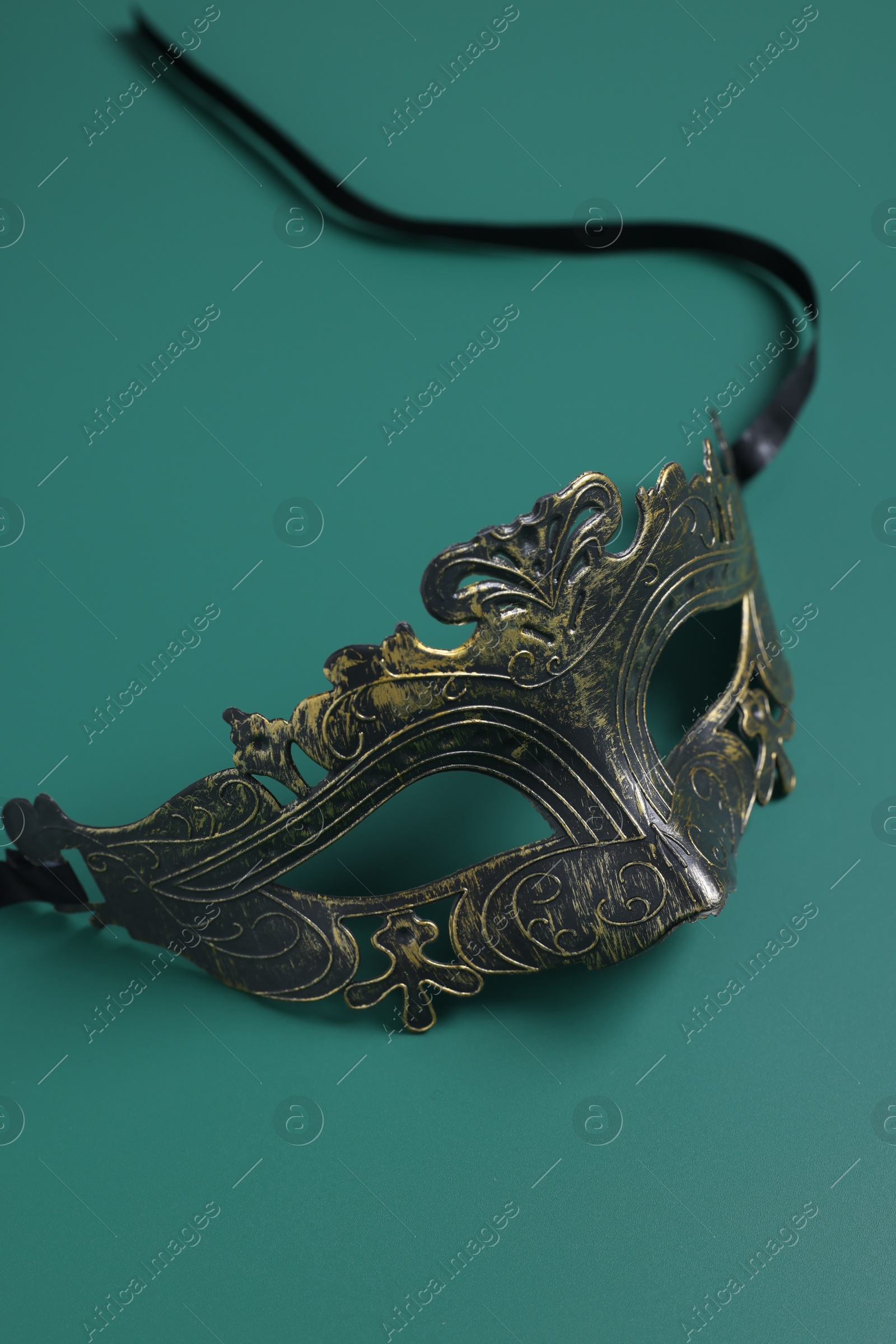 Photo of One beautiful carnival mask on teal background