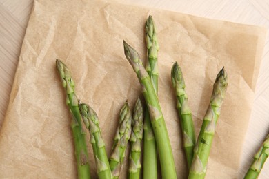 Fresh green asparagus stems on table, top view