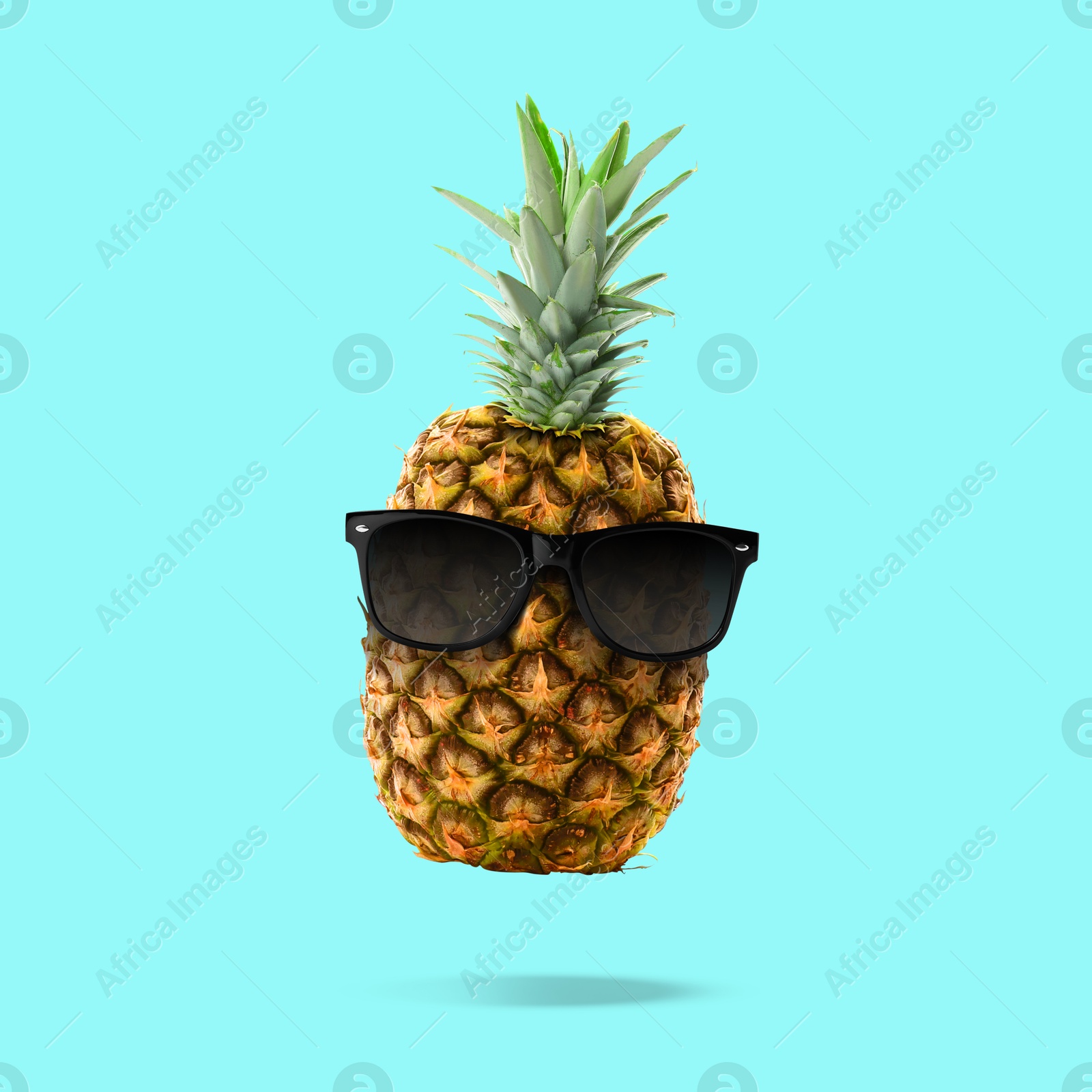 Image of Summer vibe. Pineapple with sunglasses on turquoise background. Party flyer or other seasonal