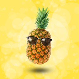 Image of Summer vibe. Pineapple with sunglasses on yellow background, bokeh effect. Party flyer or other seasonal