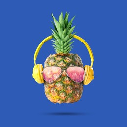 Image of Summer vibe. Pineapple with sunglasses and headphones on blue background. Party flyer or other seasonal