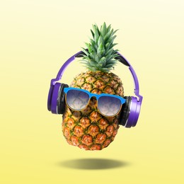 Image of Summer vibe. Pineapple with sunglasses and headphones on yellow gradient background. Party flyer or other seasonal