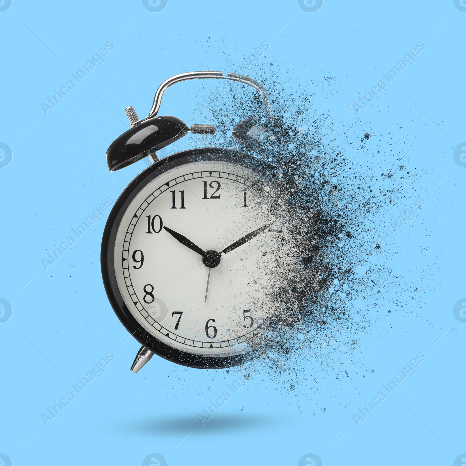 Image of Black alarm clock dissolving on light blue background. Flow of time