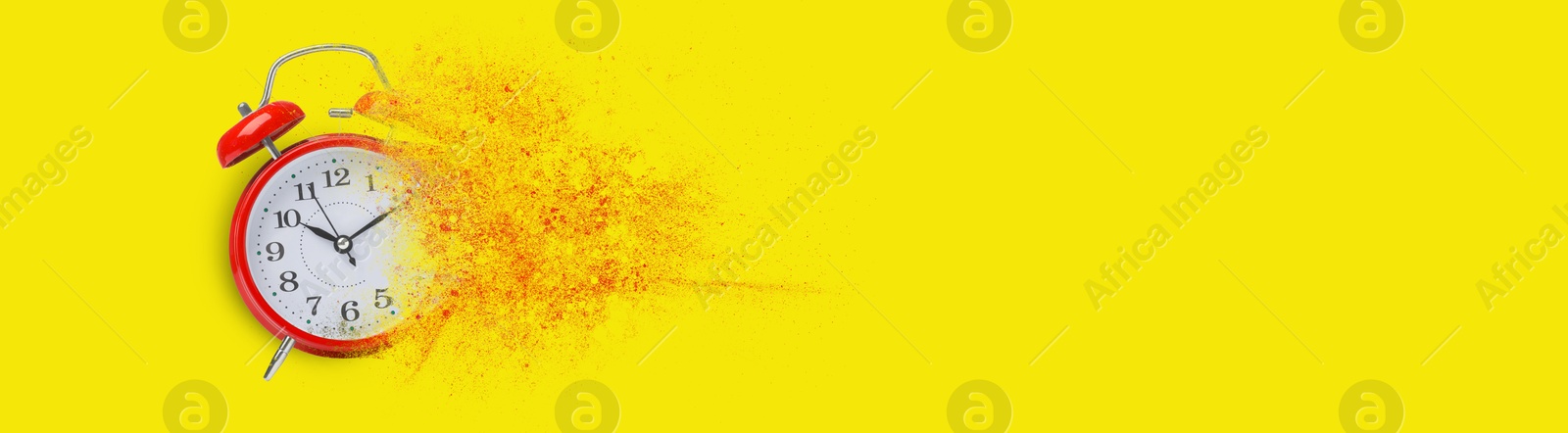 Image of Red alarm clock dissolving on yellow background, banner design with space for text. Flow of time