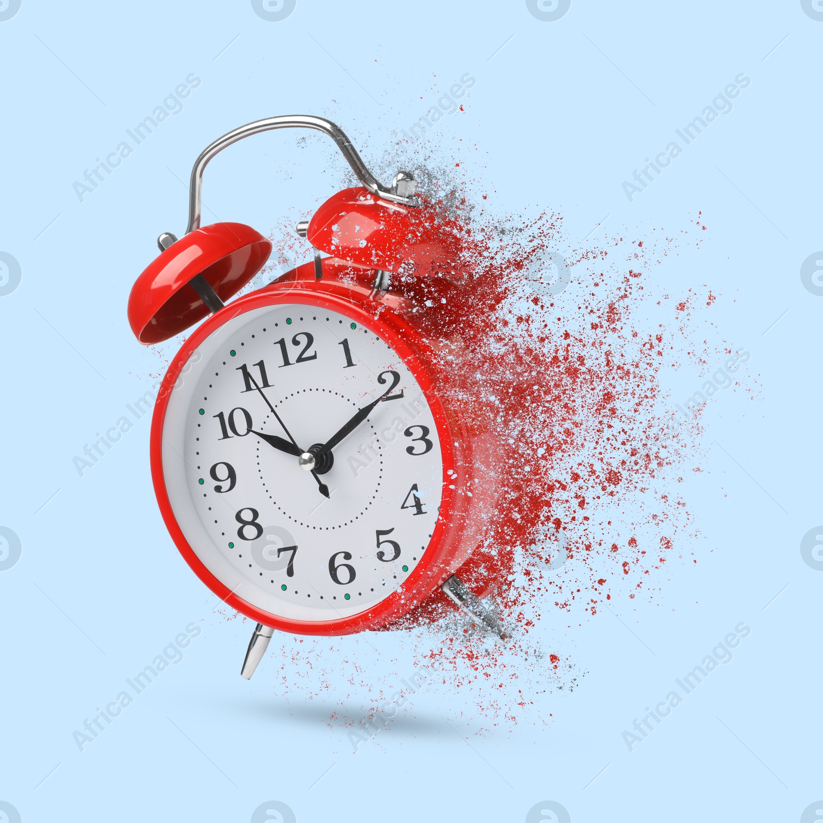 Image of Red alarm clock dissolving on light blue background. Flow of time