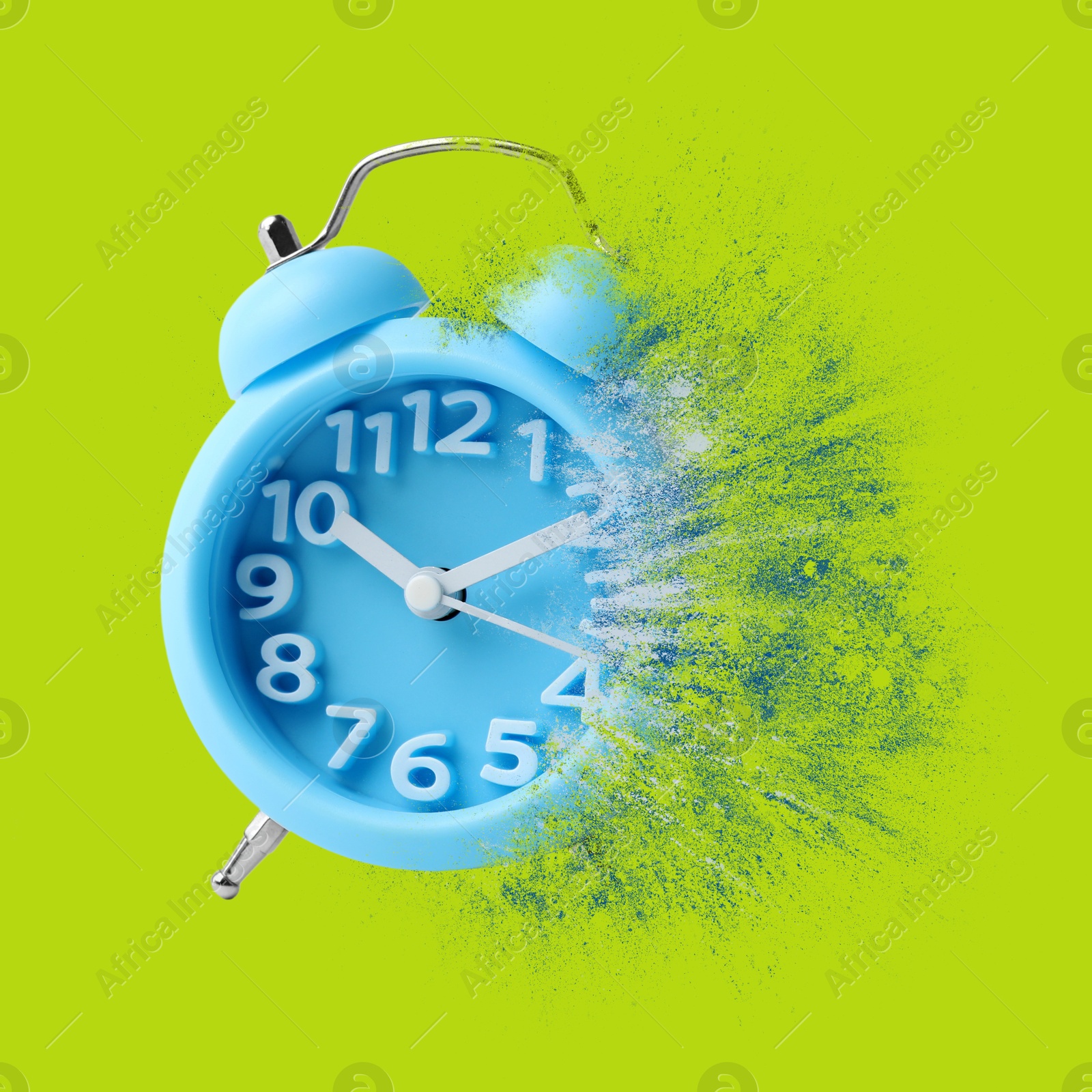 Image of Light blue alarm clock dissolving on green background. Flow of time