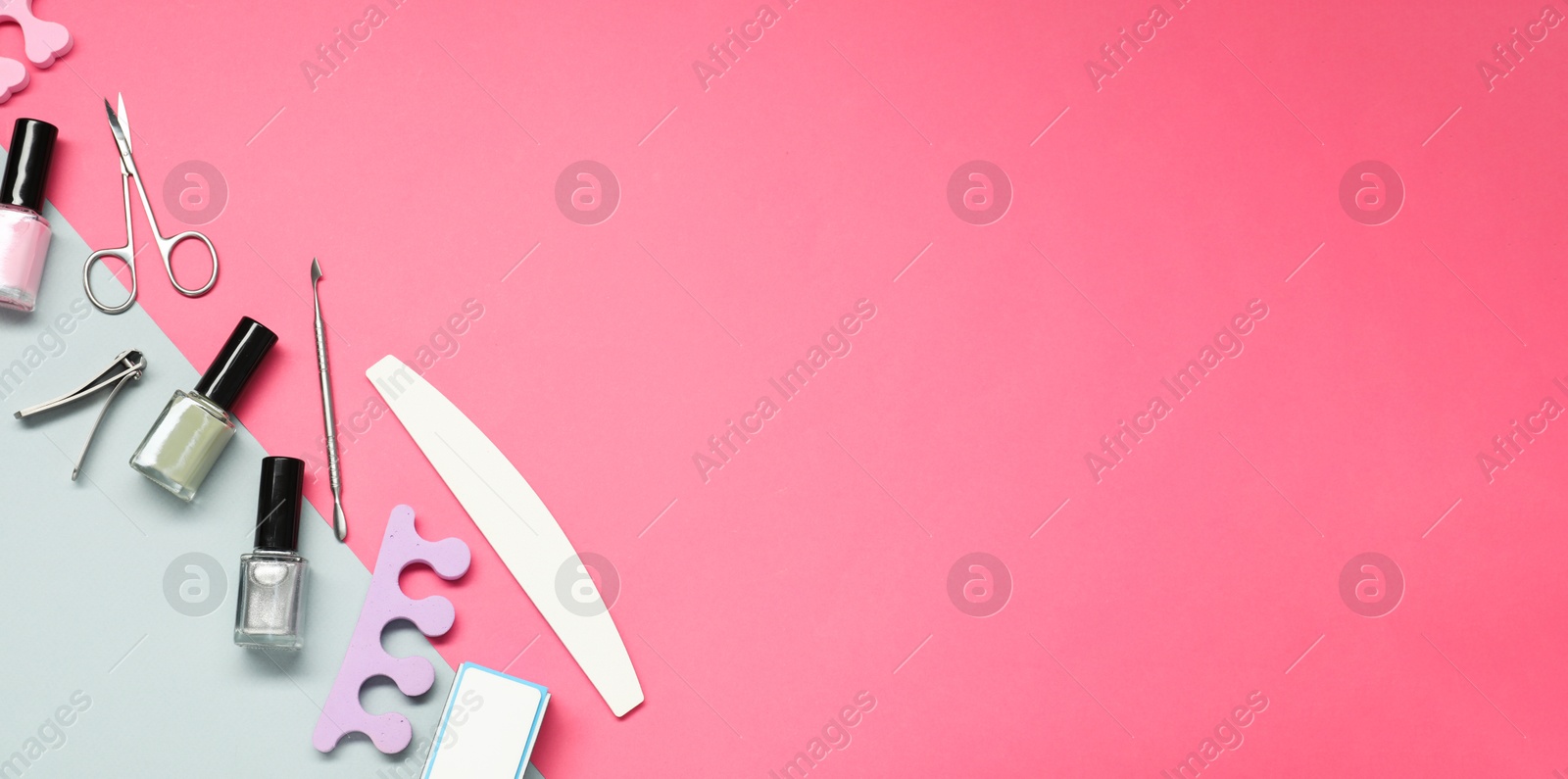 Image of Nail polishes and set of pedicure tools on pink background, flat lay. Banner design with space for text