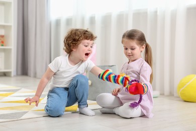 Photo of Cute little children playing with funny sock puppets in kindergarten