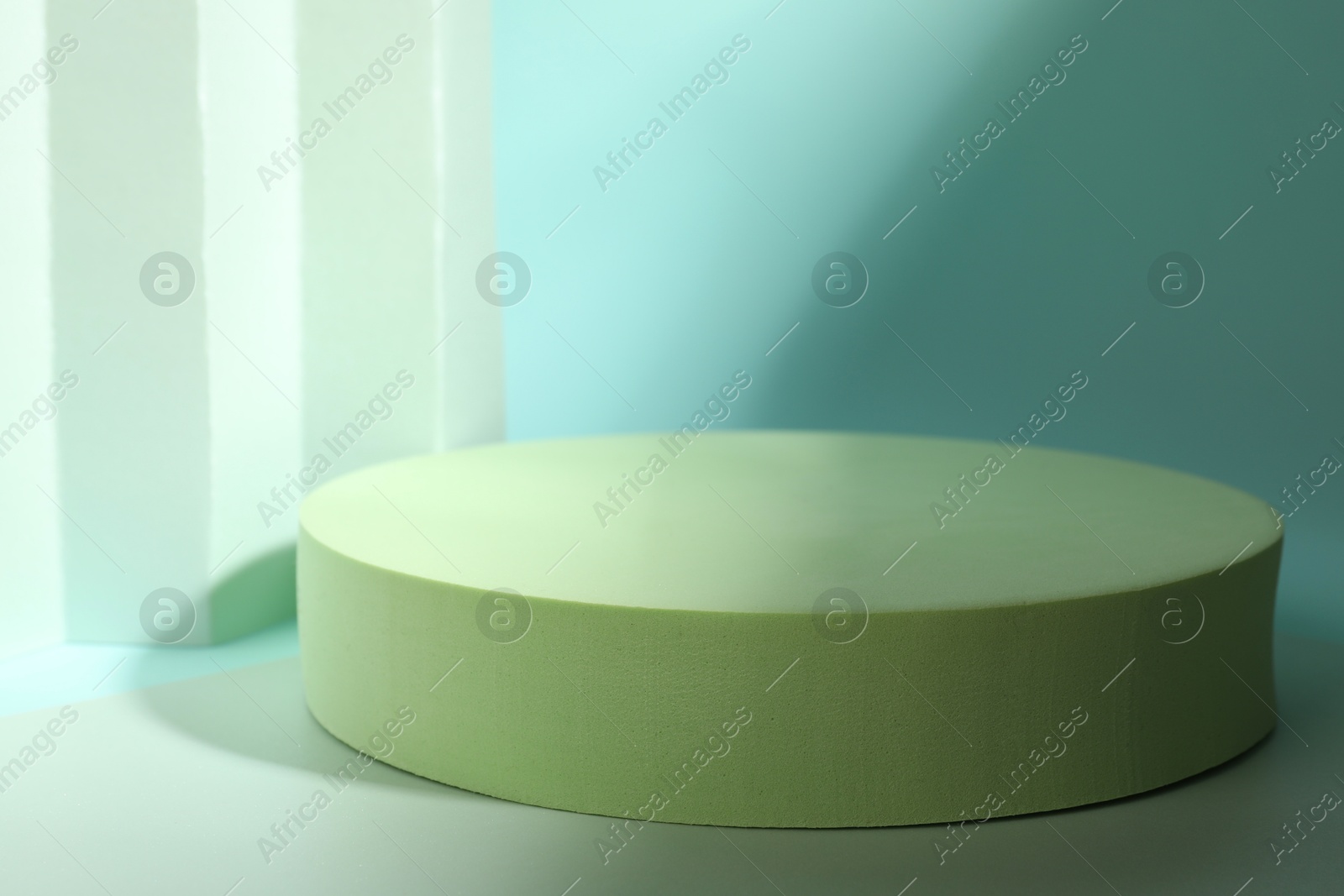 Photo of Presentation of product. Podium, paper and shadows on turquoise background. Space for text