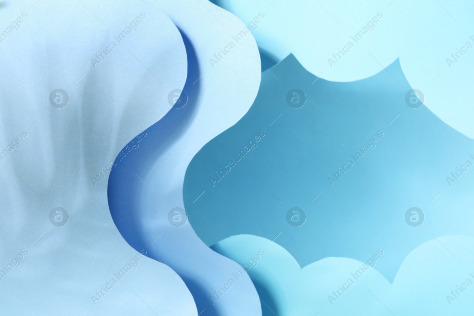 Photo of Presentation of product. Paper cutouts and shadows on light blue background. Space for text