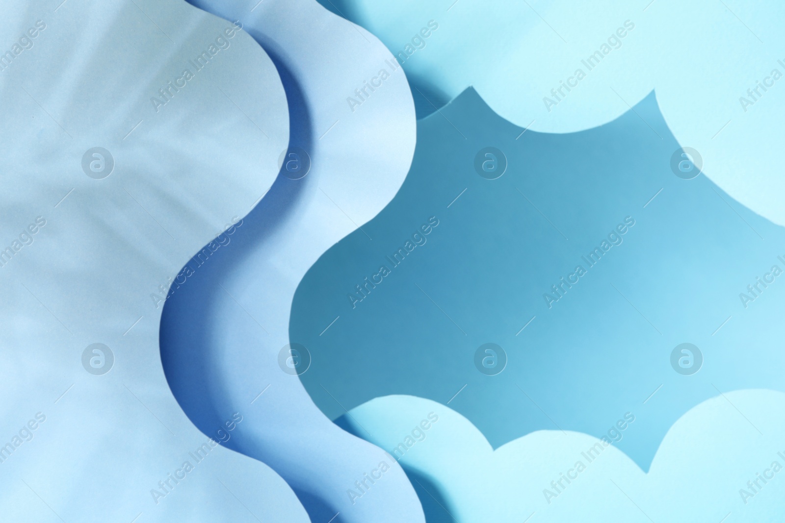 Photo of Presentation of product. Paper cutouts and shadows on light blue background. Space for text