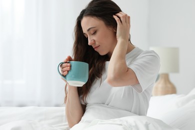 Photo of Woman drinking coffee in bed at home. Good morning