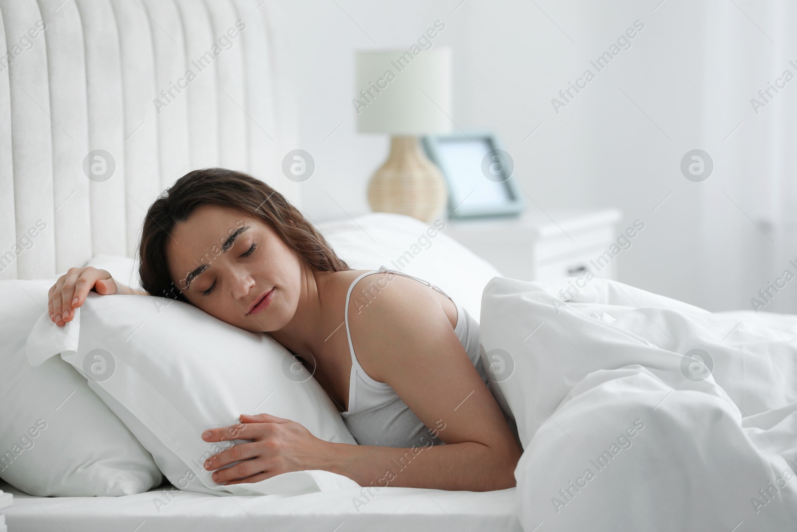 Photo of Bedtime. Beautiful woman sleeping in bed at home