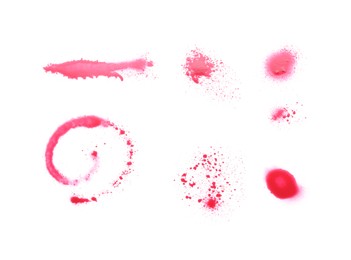 Photo of Abstract spots made with red spray paint isolated on white, top view