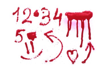 Photo of Different symbols made with red spray paint isolated on white, top view