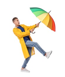 Young man with rainbow umbrella on white background