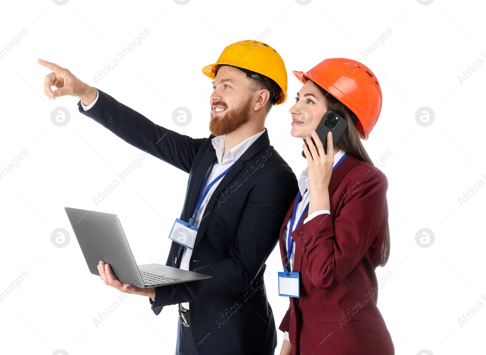 Photo of Engineer holding laptop while his colleague talking on smartphone against white background