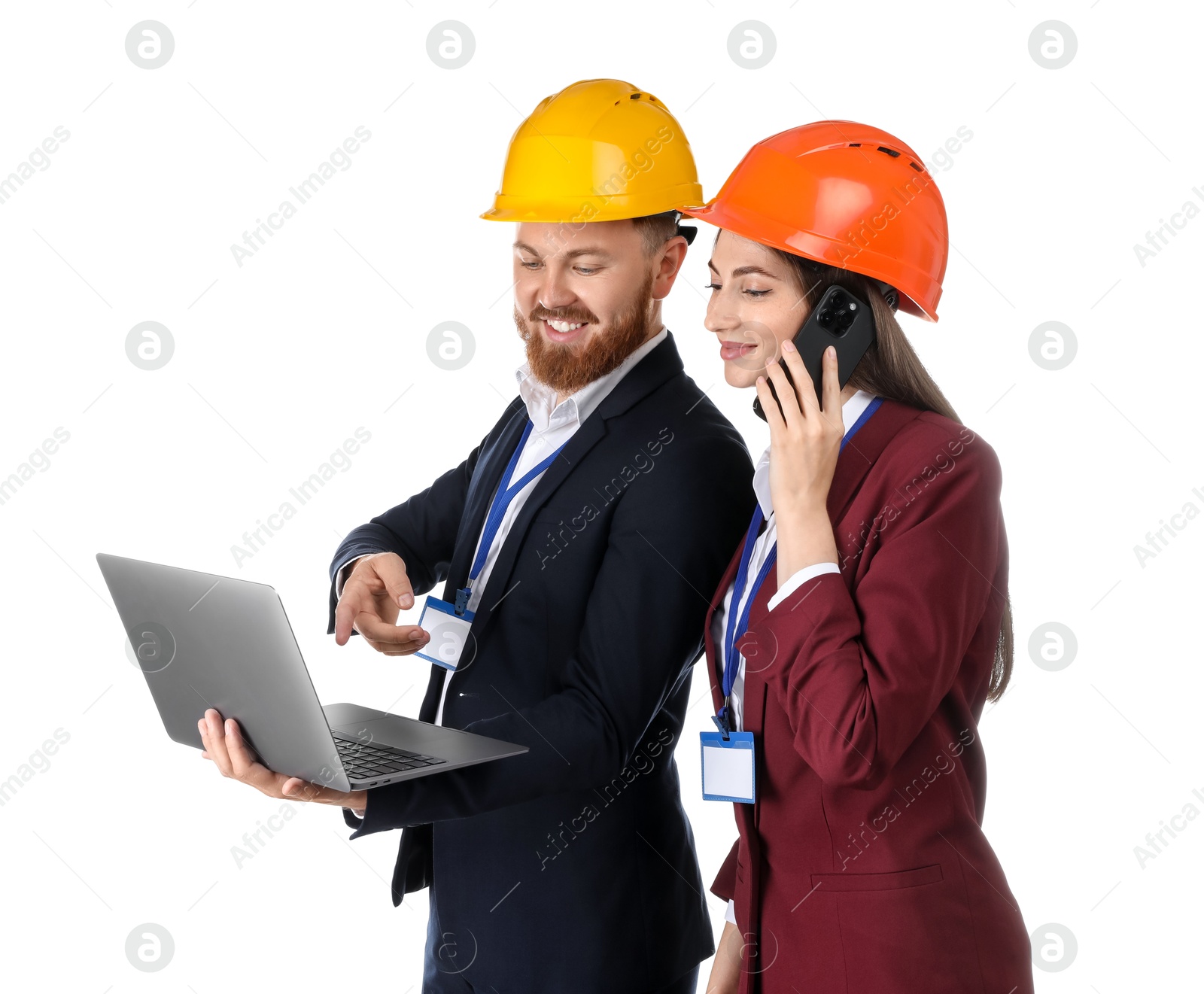 Photo of Engineer holding laptop while his colleague talking on smartphone against white background