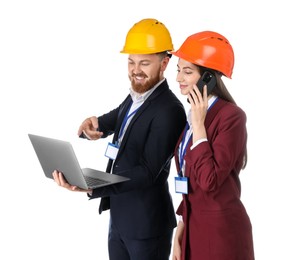 Engineer holding laptop while his colleague talking on smartphone against white background